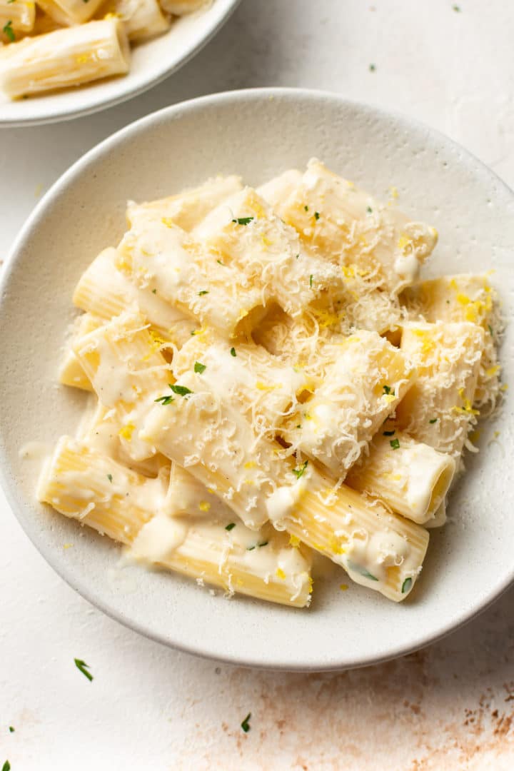 close-up of creamy lemon pasta in white bowl