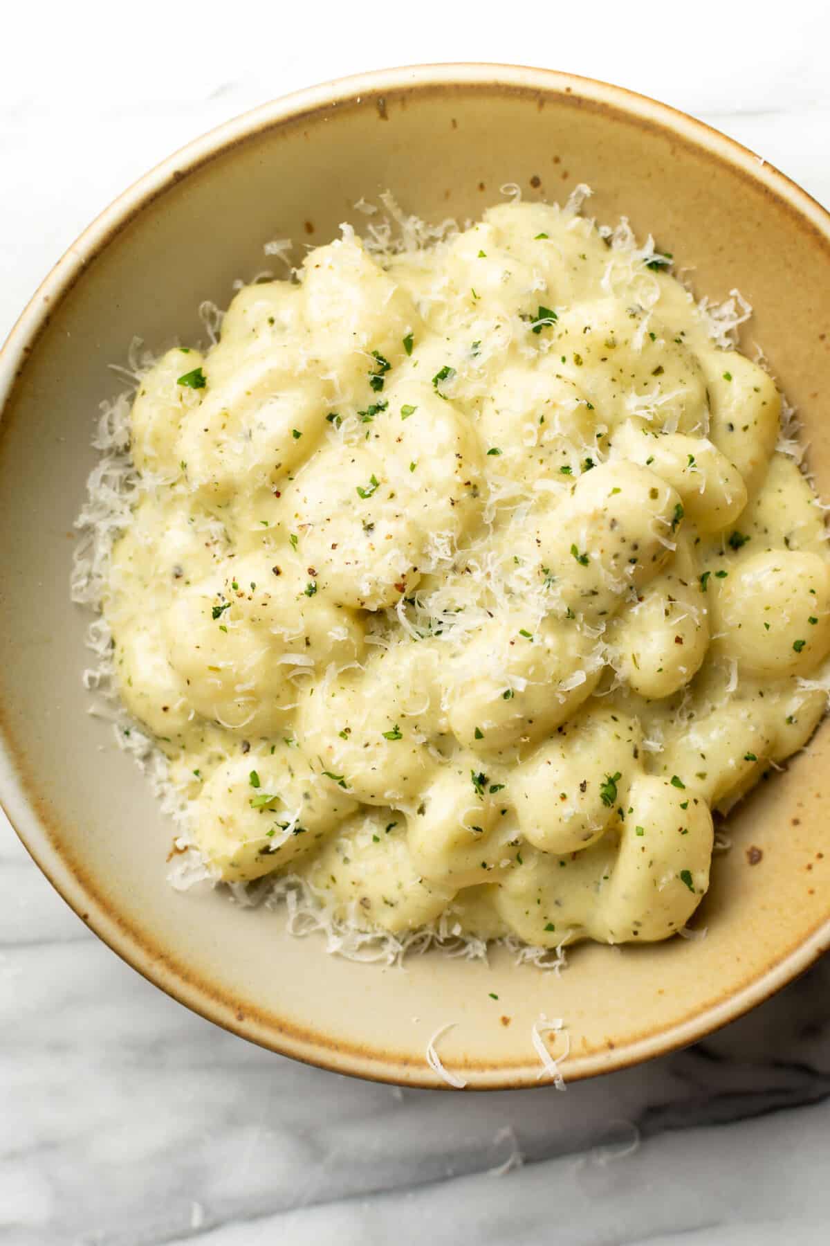 a bowl of creamy pesto gnocchi