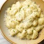 a bowl of creamy pesto gnocchi