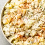 classic potato salad with egg in a beige serving bowl