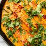 a cast iron skillet with salmon coconut curry