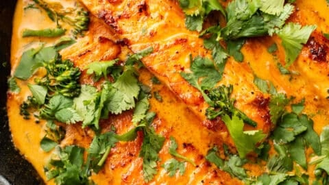 a cast iron skillet with salmon coconut curry