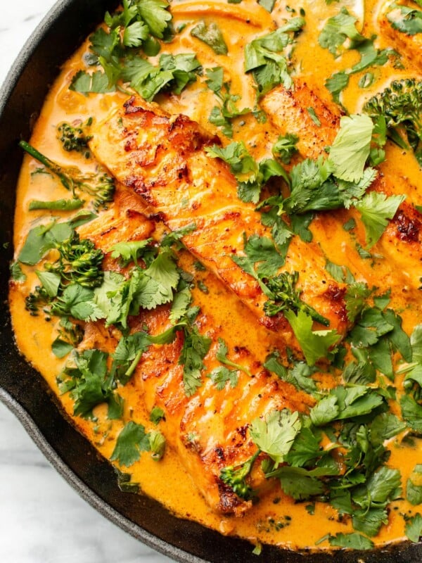 a cast iron skillet with salmon coconut curry