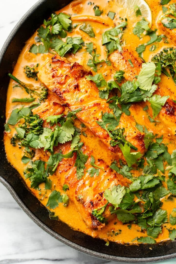 a cast iron skillet with salmon coconut curry