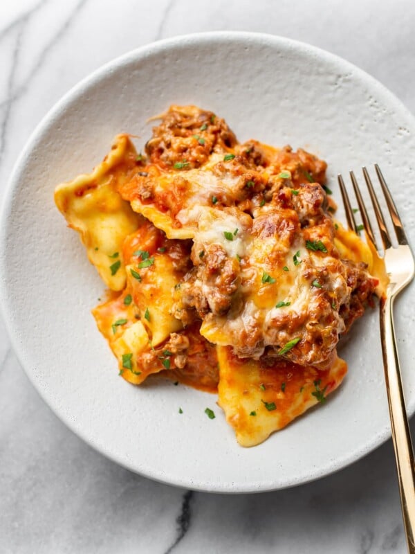 cheesy baked ravioli in a shallow bowl