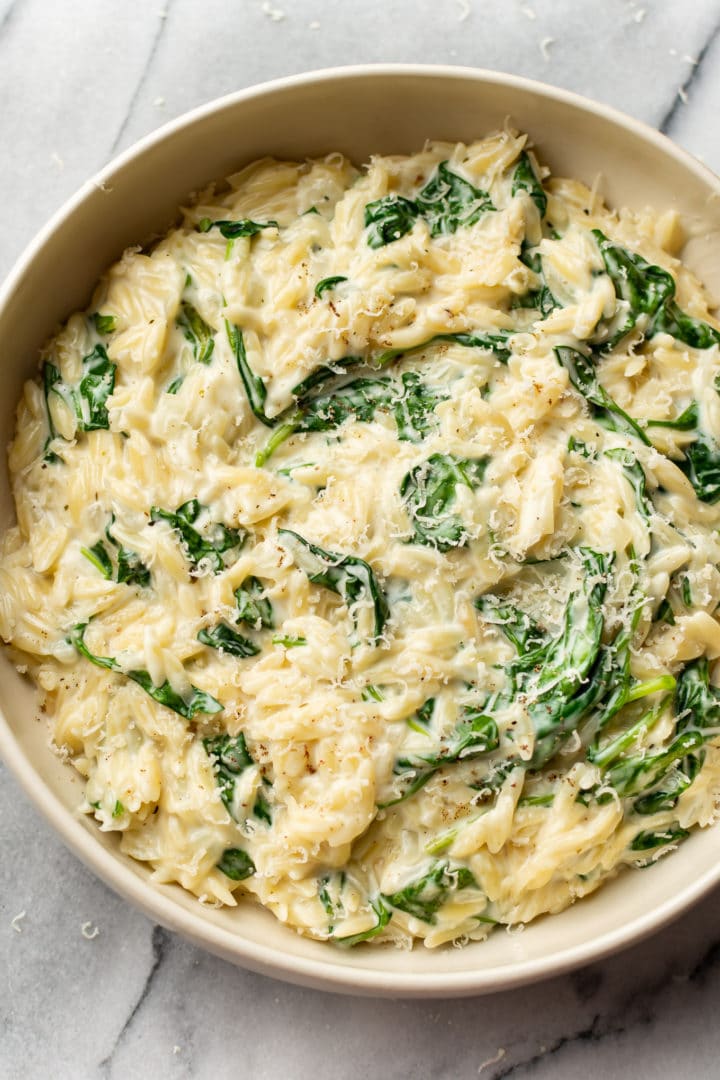 creamy orzo with spinach in a serving bowl
