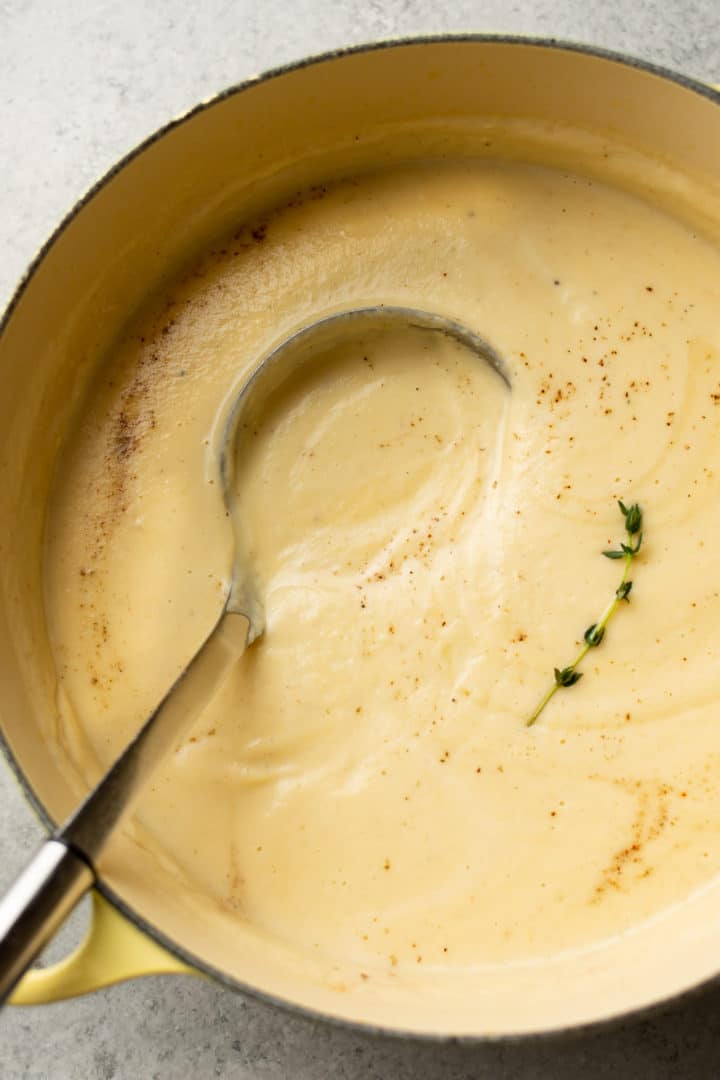 creamy cauliflower soup in a pot with a ladle