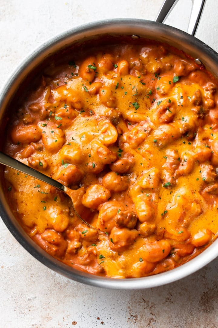 creamy cheesy sausage gnocchi in a skillet