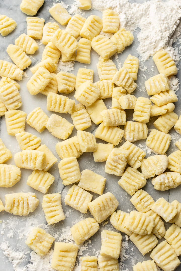 homemade gnocchi on a marble pastry board