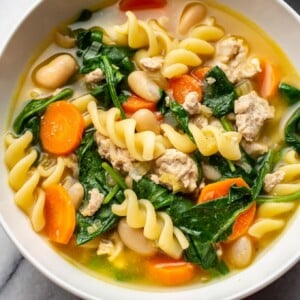 close-up of ground turkey soup in a white bowl