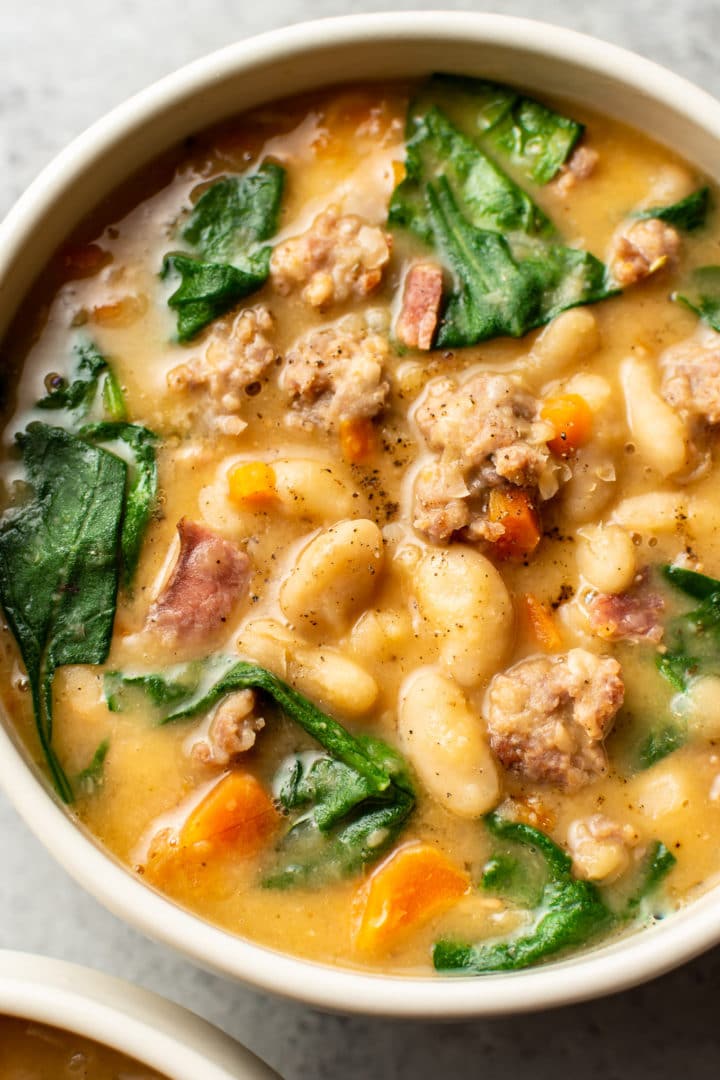 Italian sausage white bean soup close-up in a bowl