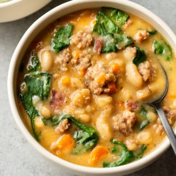 Italian sausage white bean soup (two bowls) with a spoon