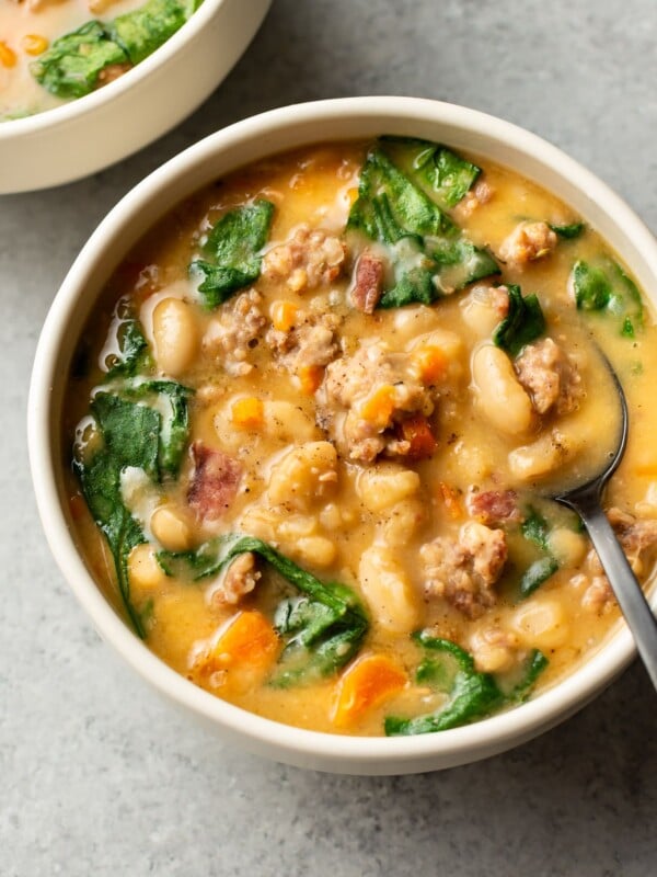 Italian sausage white bean soup (two bowls) with a spoon