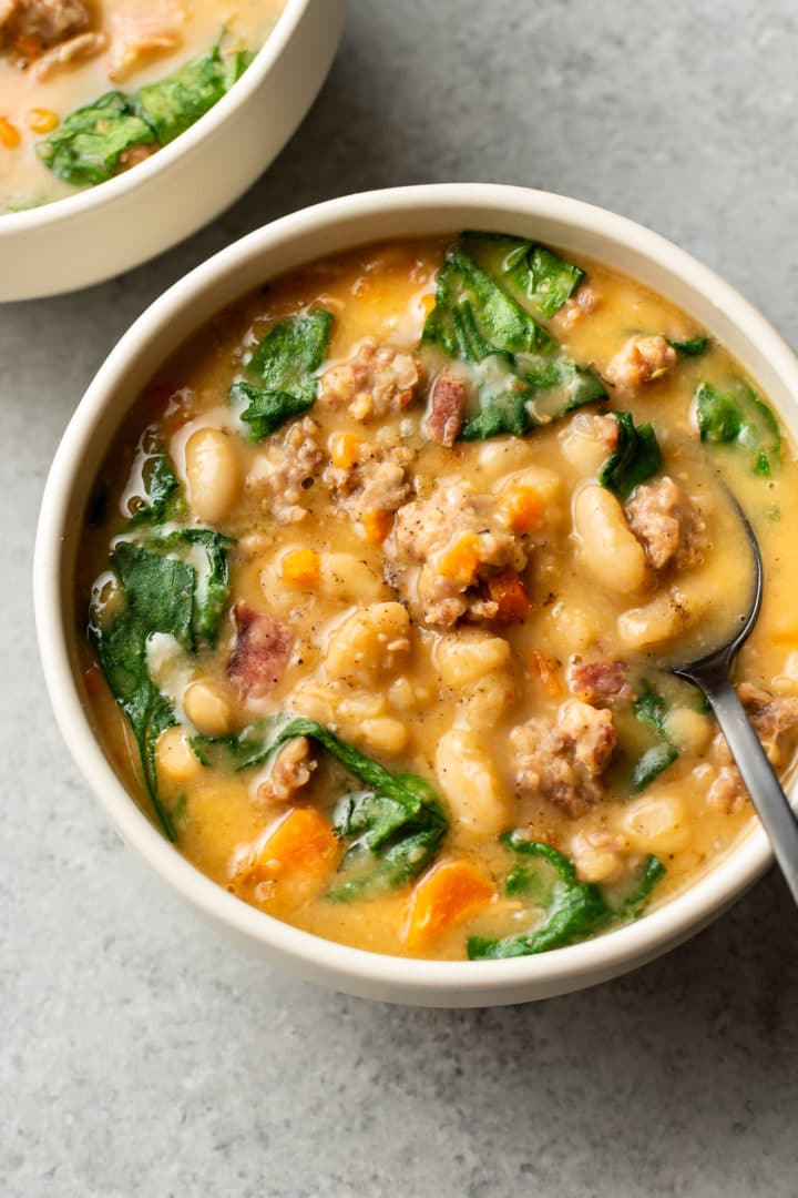 Italian sausage white bean soup (two bowls) with a spoon