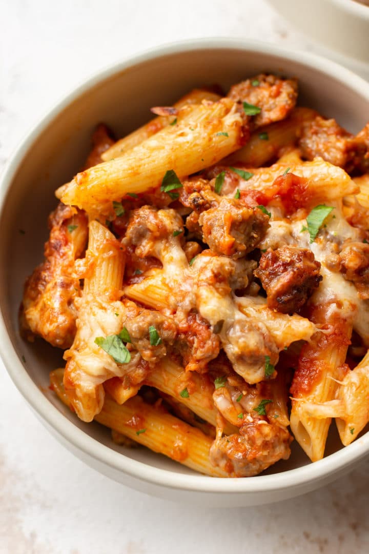 a bowl of baked penne with sausage