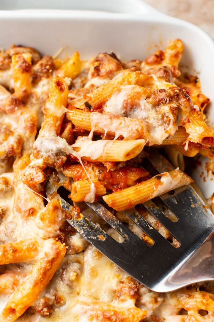 close-up of cheesy sausage penne bake (with cheese pull)