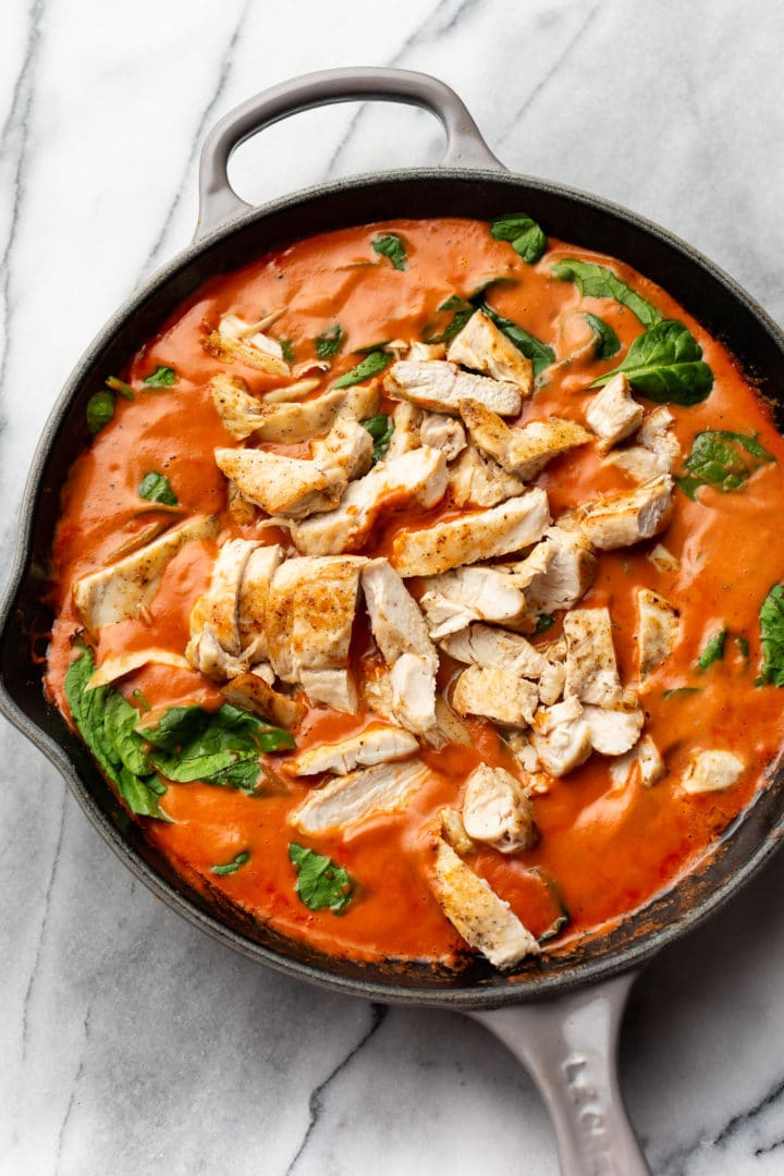 skillet with chicken tomato spinach pasta sauce