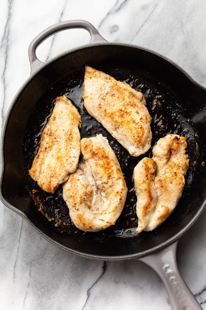 skillet with seared chicken breast