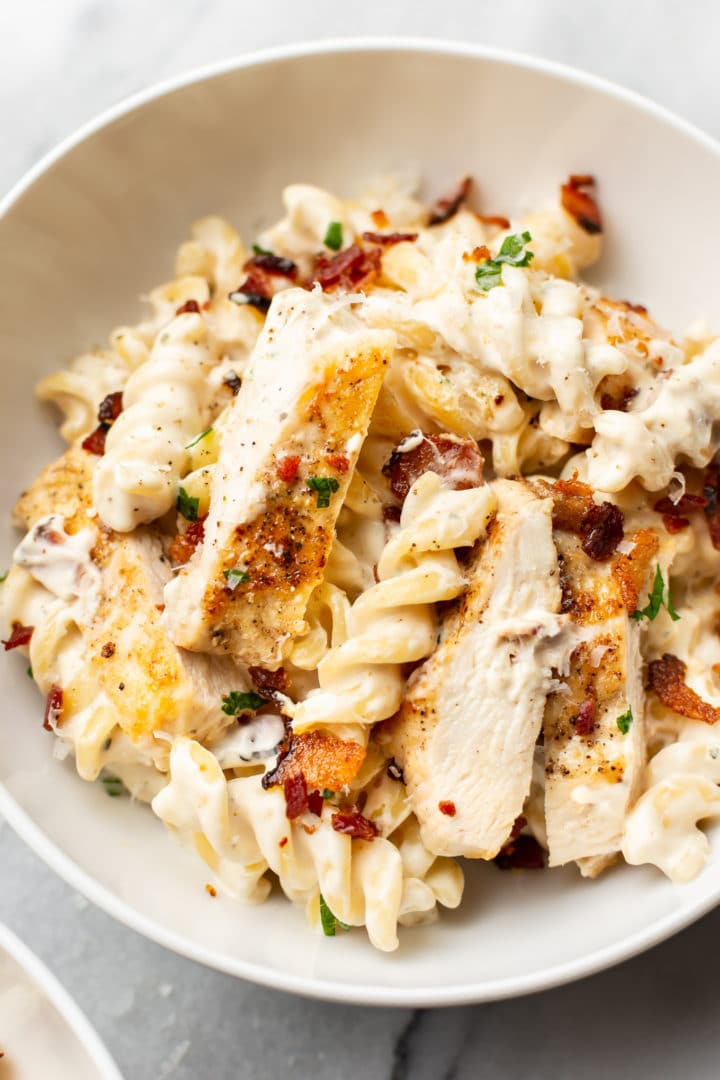 close-up of chicken bacon ranch pasta in a white bowl