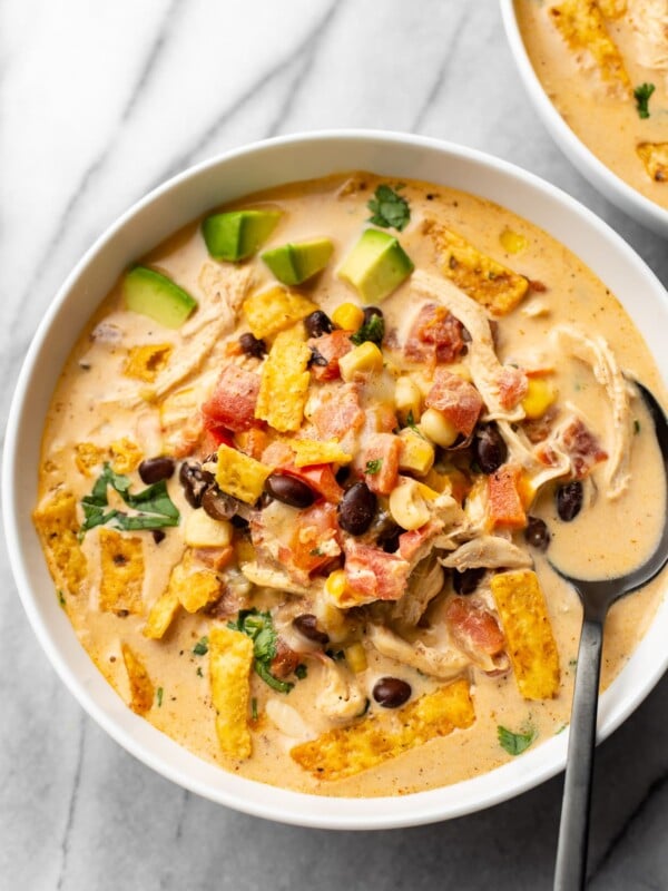 creamy chicken taco soup in two white bowls