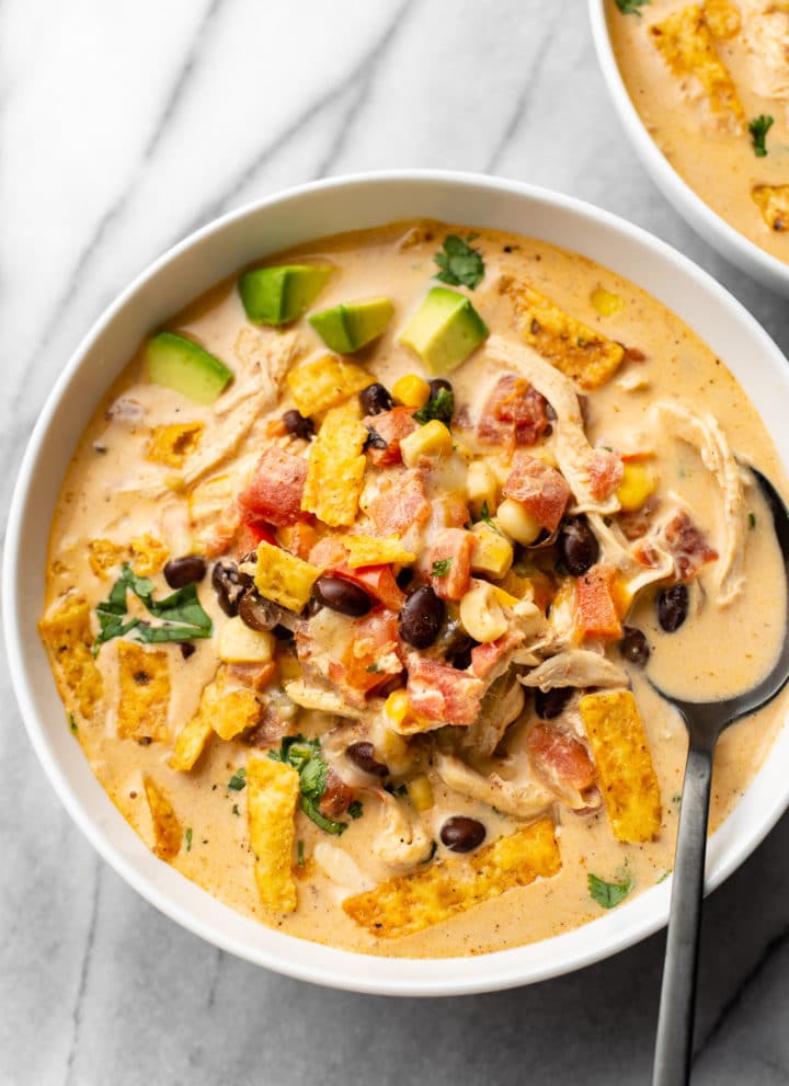 creamy chicken taco soup in two white bowls