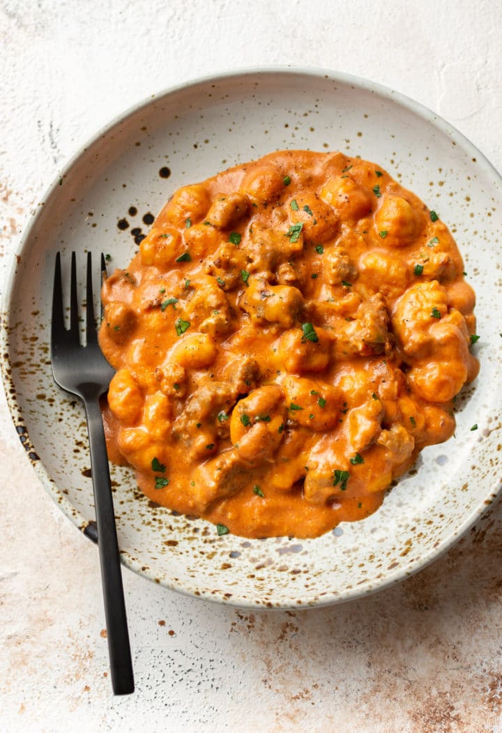 cheesy bratwurst sausage gnocchi in a shallow bowl