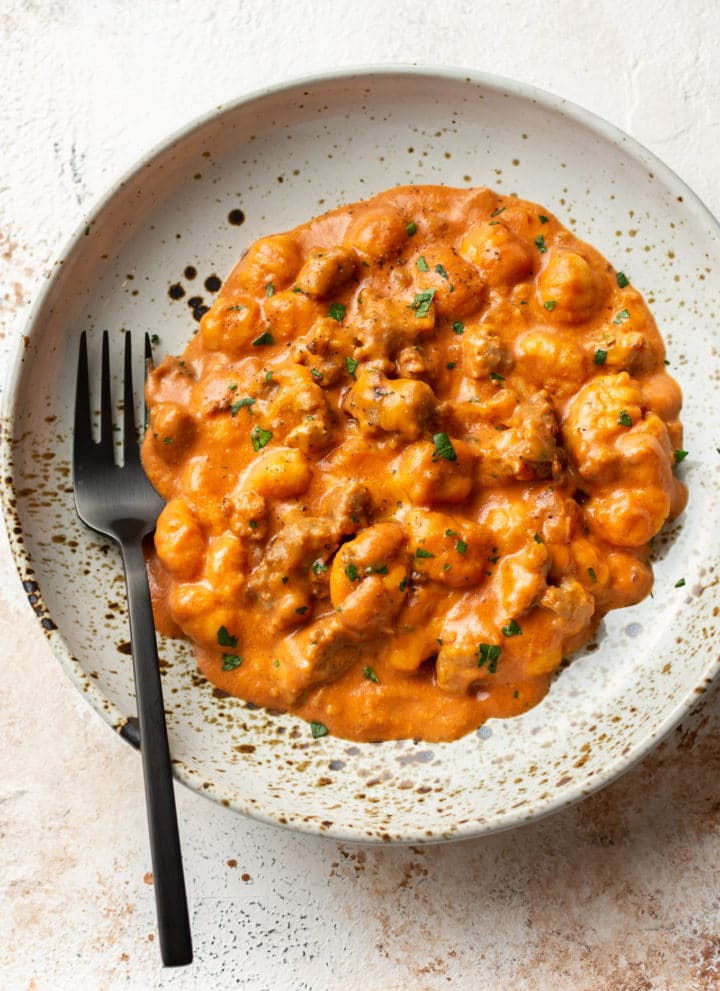 cheesy bratwurst sausage gnocchi in a shallow bowl