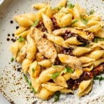 sun-dried tomato chicken pasta close-up in a shallow bowl