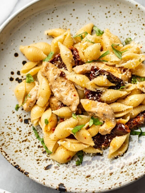 sun-dried tomato chicken pasta close-up in a shallow bowl