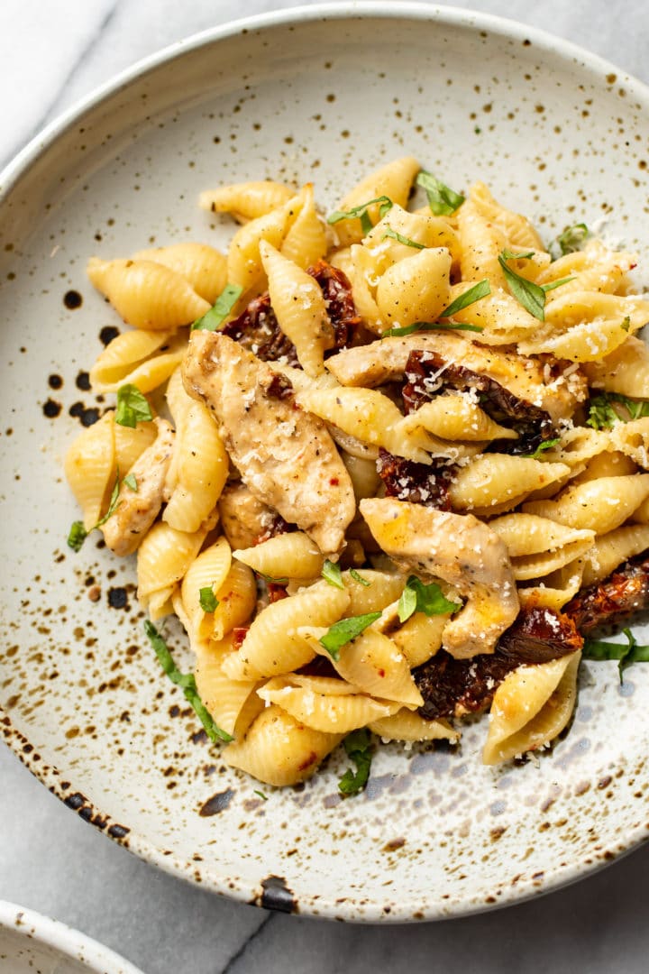 sun-dried tomato chicken pasta close-up in a shallow bowl