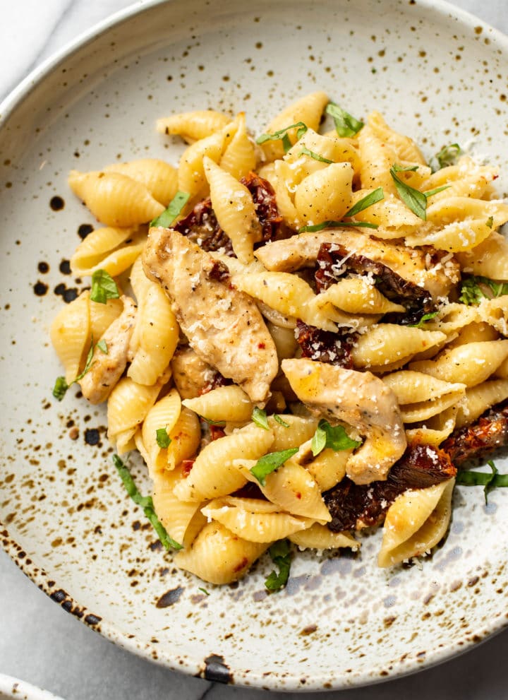 sun-dried tomato chicken pasta close-up in a shallow bowl