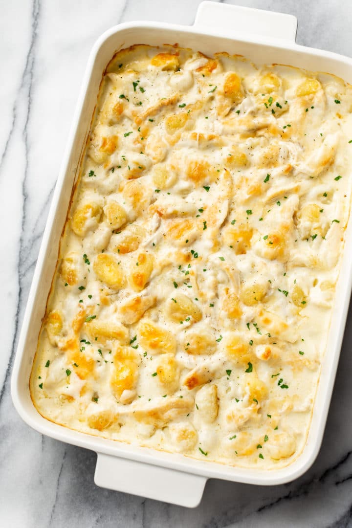 chicken alfredo gnocchi bake in a white 9x13 baking dish