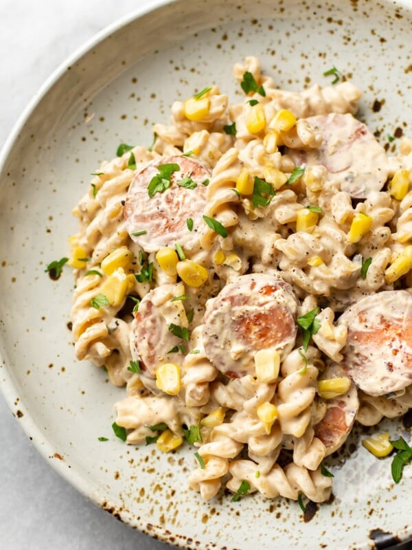 creamy smoked sausage pasta in a beige bowl