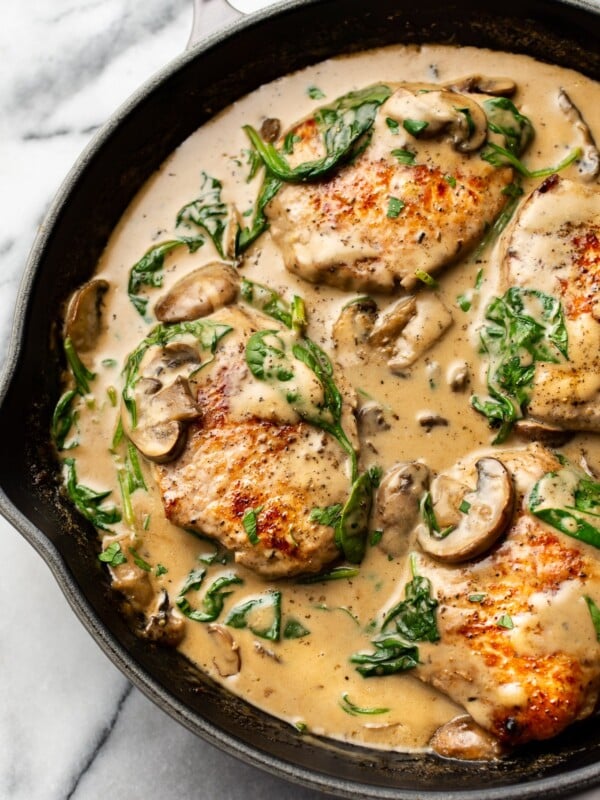 creamy spinach mushroom pork chops in a skillet