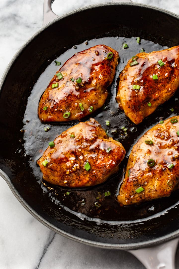 honey garlic chicken breasts in a cast iron skillet