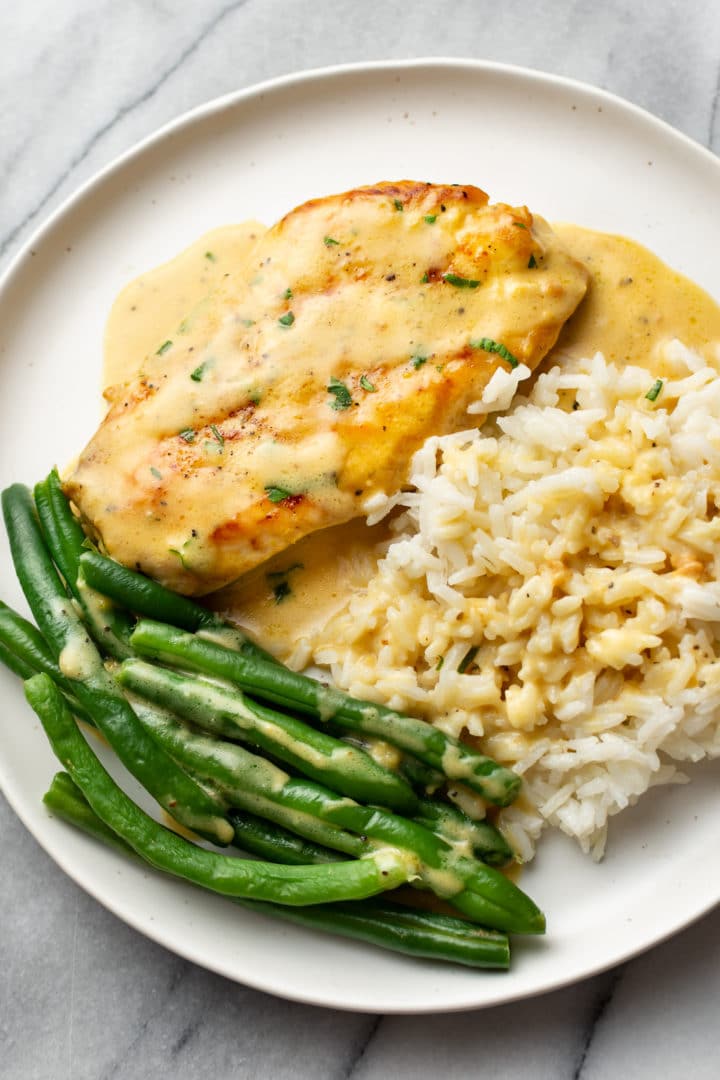 lemon pepper chicken on a plate with green beans and rice