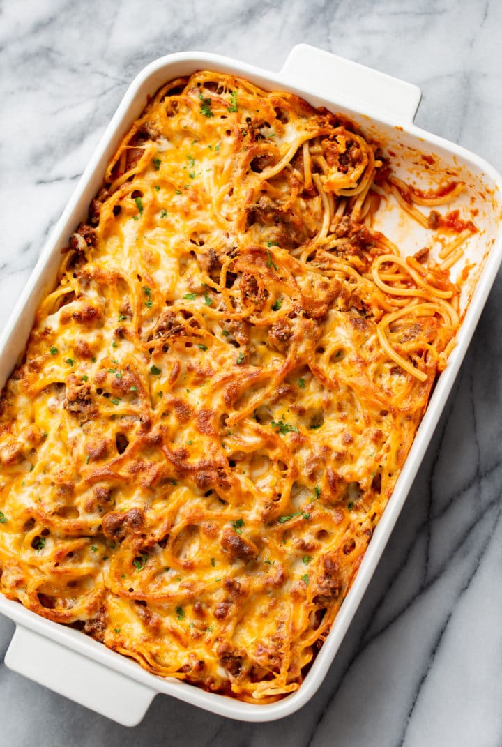 the best baked spaghetti in a casserole dish with a corner piece taken out