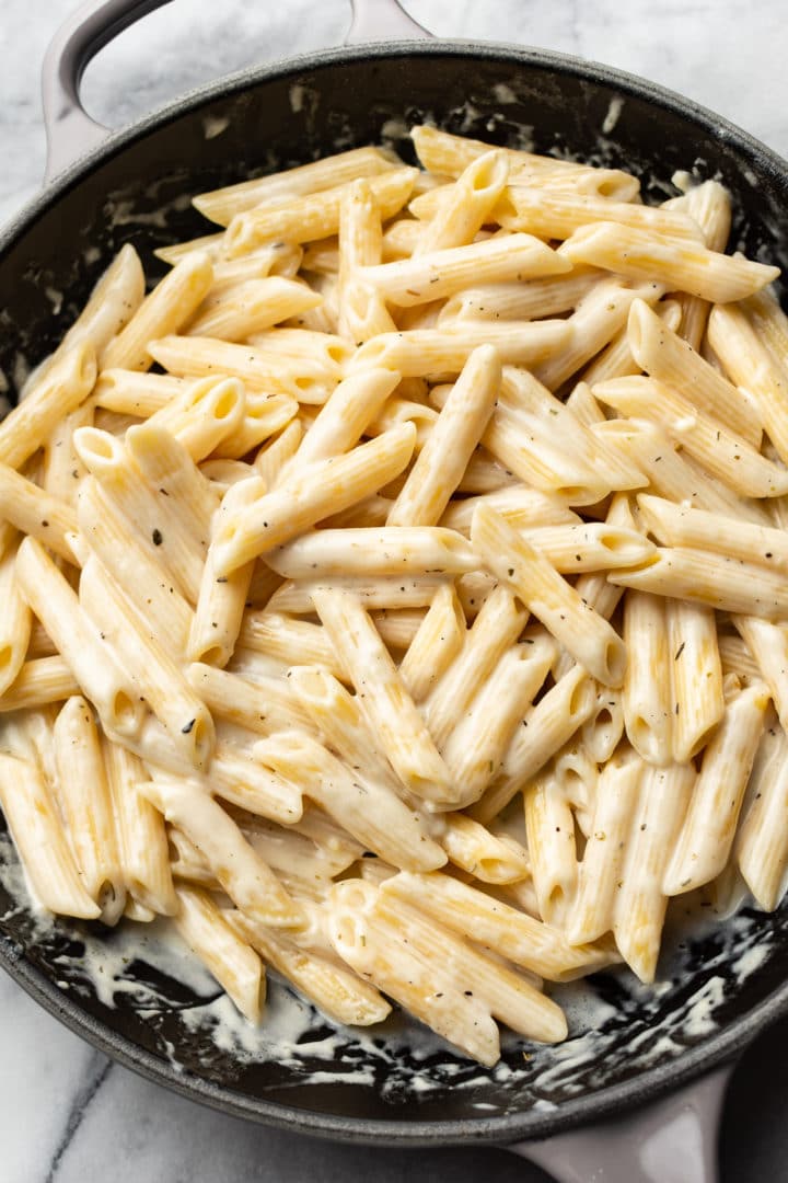 creamy garlic parmesan penne pasta in a skillet