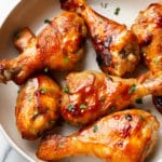 sticky honey baked drumsticks arranged in a bowl