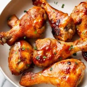 sticky honey baked drumsticks arranged in a bowl