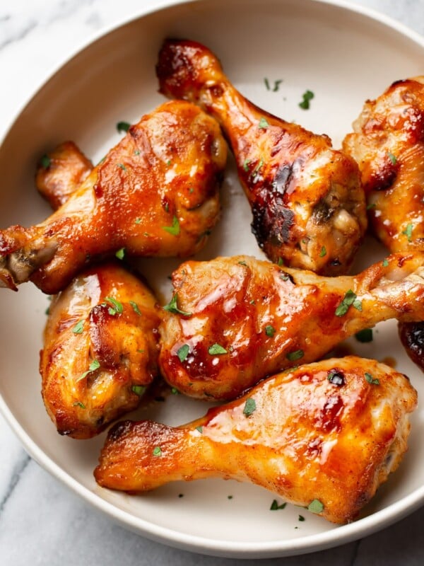 sticky honey baked drumsticks arranged in a bowl