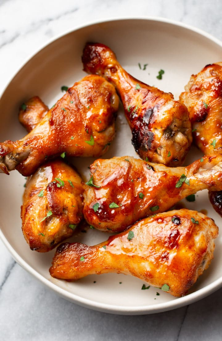 sticky honey baked drumsticks arranged in a bowl