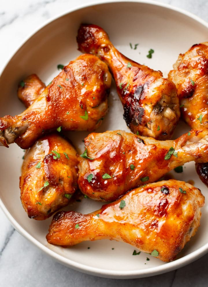 sticky honey baked drumsticks arranged in a bowl