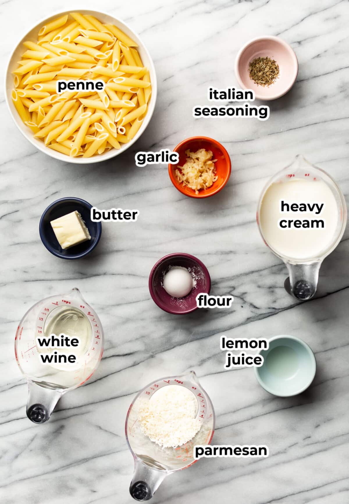 ingredients for creamy penne pasta in prep bowls and measuring cups