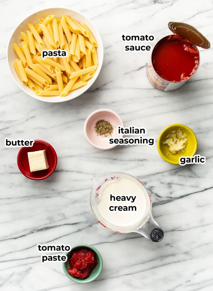 ingredients for creamy tomato pasta in prep bowls