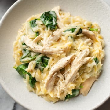 close-up of lemon chicken orzo in two white shallow bowls