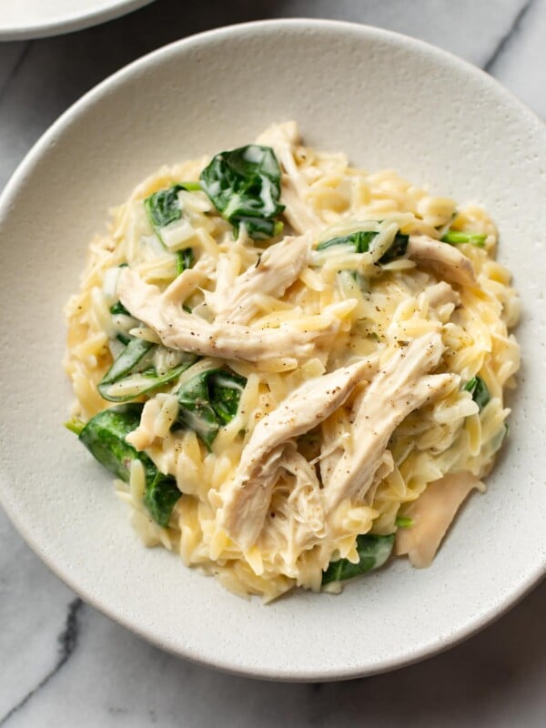 close-up of lemon chicken orzo in two white shallow bowls