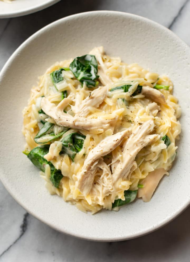 close-up of lemon chicken orzo in two white shallow bowls