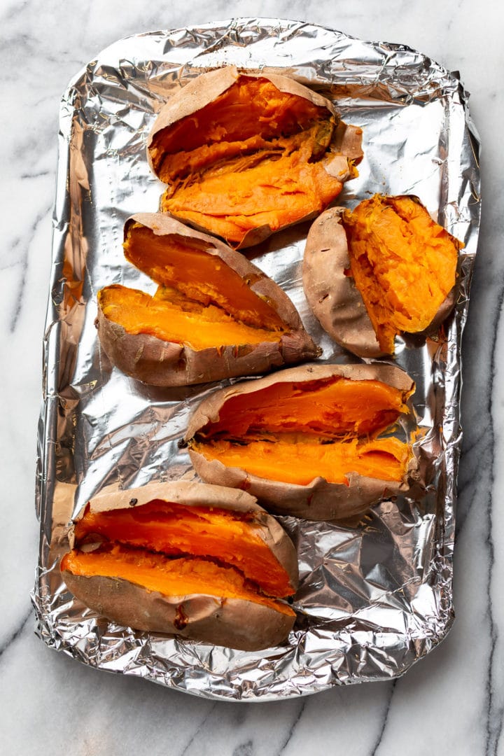 baked sweet potatoes on a baking sheet