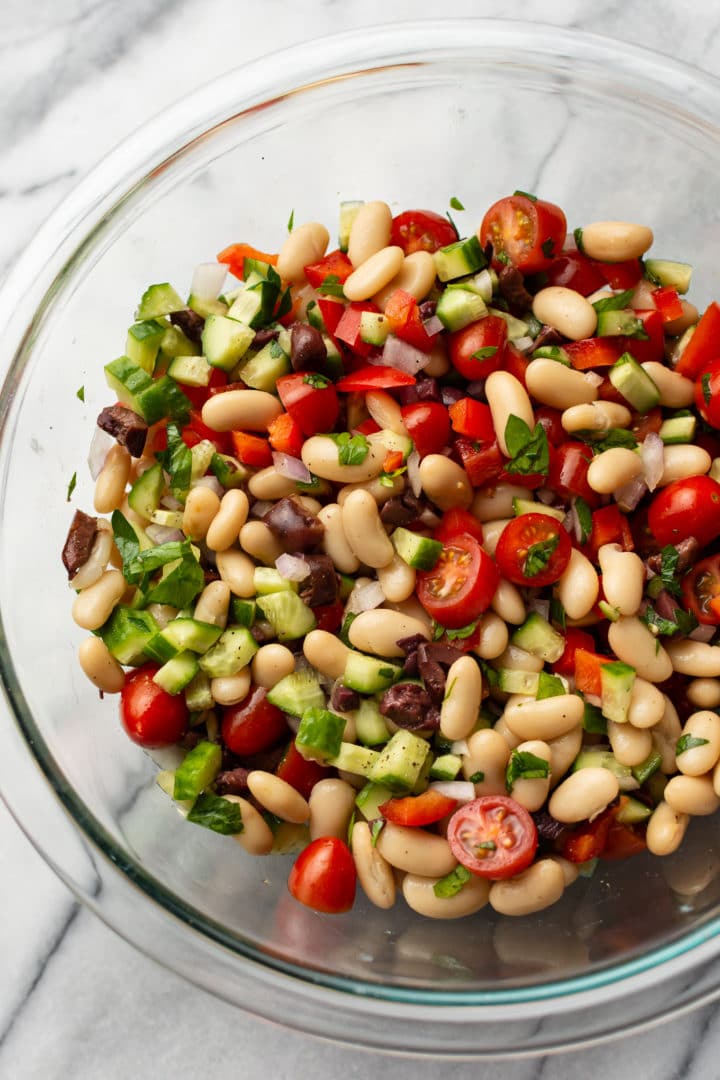 mediterranean white bean salad in a glass prep bowl